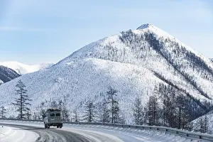 Deserted Mountain Roads Prints: Minivan driving on the Road of Bones