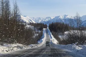 Uninhabited Mountain Ranges Prints: Minivan driving on the Road of Bones