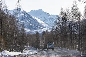 Deserted Mountain Roads Prints: Minivan driving on the Road of Bones
