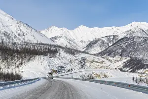 Uninhabited Mountain Ranges Prints: Minivan driving on the Road of Bones