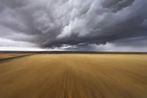 American Countryside Scenes Prints: A Mirage on high speed.Thunderclouds above fields after harvesting