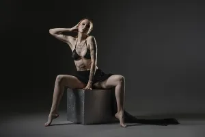 Creative Studio Shot Prints: The model showcases an elegant pose on a cube