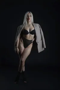 Confident Model Pose Prints: A model stands confidently in a dark studio