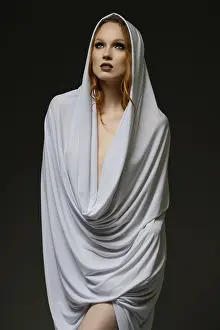 Makeup And Cosmetics Prints: A model stands gracefully, enveloped in light fabric