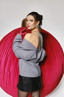 Fashion Studio Photography Prints: A model stands against a large red circular backdrop