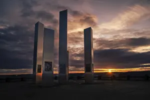 Deserted Evening Sun Germany Prints: Modern sculptures in front of a dramatic sunset sky with reflections