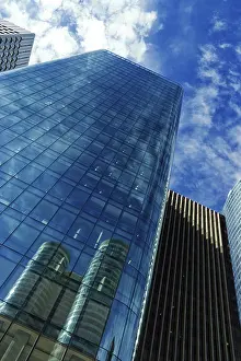 Contemporary Urban Landscape Prints: Modern skyscraper under cloudy blue sky