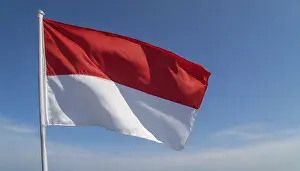 Blue Sky National Symbol Prints: The Monaco flag flutters in the wind