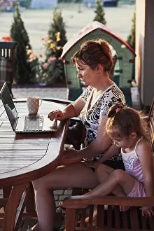 Home Office Setup Ideas Prints: Mother working at home, using portable computer