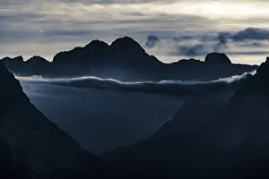 Dramatic Cloudy Atmosphere Prints: Mountain top of the Dolomites with dramatic cloudy sky