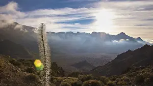 Volcanic Mountain Range Prints: Mountain landscape at sunset with dramatic clouds and distant mountains