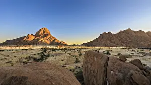 Namibia Landscape Prints: A mountain in Namibia glows orange in the evening light