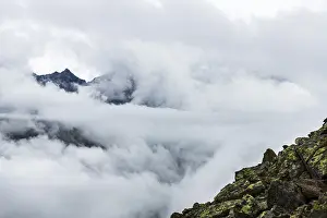 Tyrol Mountains Prints: Mountain peak rises from clouds