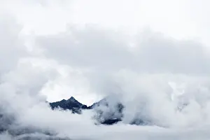 Austria Landscape Prints: Mountain peak rises from clouds