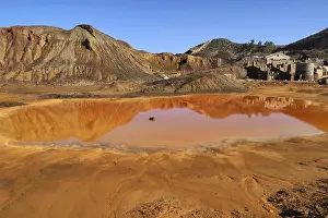 Raw Material Extraction Europe Prints: Mountain with red puddle and mine building