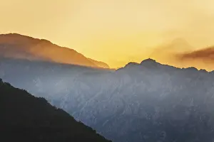 Atmospheric Light Of The Setting Sun Prints: Mountain sunset and colored sky with clouds