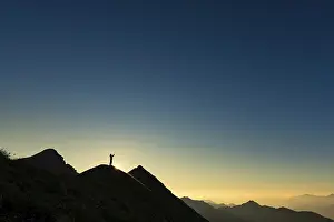 Alpine Sport Tourism Prints: Mountaineer on summit ridge with backlight