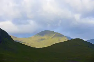 Northern Europe Nature Scenery Prints: Mountains in sunlight against a cloudy sky
