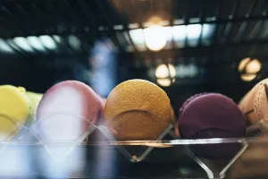 Colorful Sweets Display Prints: Multicolored macarons on a showcase in a cafe