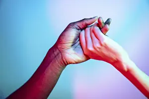 Colorful Diversity Prints: Multiethnic hands clasped together symbolizing unity and diversity
