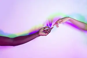 Multiethnic Unity Prints: Two multiethnic hands reaching towards each other against a vibrant background with dynamic