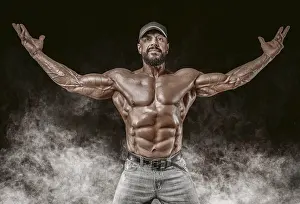 Bodybuilding Pose Prints: Muscular athlete posing in the studio
