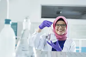 Female Healthcare Professional Prints: Muslim lab worker doing an analysis