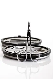 Studio Still Life Photography Prints: Nail scissors in front of a manicure set