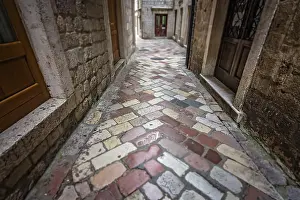Prints of Narrow cobble stoned passage between historical residential buildings in the Kotor Old Town, Montenegro Montenegro Prints: Narrow Cobble Stoned Passage in Kotor Old Town Print