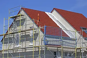 Construction Site Image Prints: New building with completed basic rendering of the exterior facade New building with completed basic rendering of
