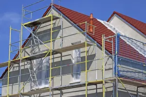 Construction Site Image Prints: New building with completed basic rendering of the exterior facade New building with completed basic rendering of
