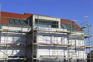 Residential Construction Site Prints: New building with completed basic rendering of the exterior facade New building with completed basic rendering of