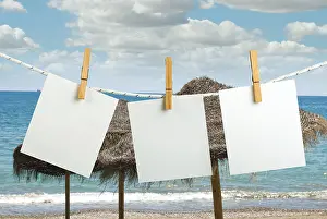 Deserted Coast Scene Prints: Note papers hooked on a rope. Beach background