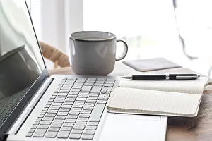 Work From Home Concept Prints: notepad and ballpoint pen on laptop computer