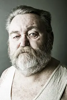 Caucasian Man Photo Prints: Obese senior with a full beard and in his undershirt