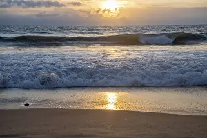 Sandy Beach At Sunset Prints: Ocean waves breaking on a sandy beach