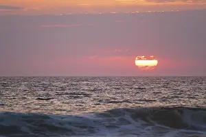 Ocean Sunset Prints: Ocean waves on sunset with setting sun background