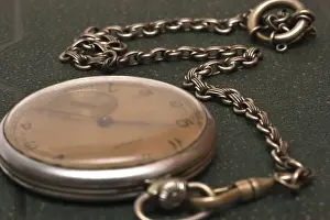 Blurry Green Background Prints: Very old clock with chain lying on rough green surface