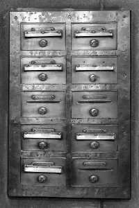 Deserted Post Office Prints: An old mailbox mounted on a wall