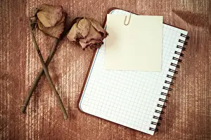 Empty Office Space Prints: Old roses and notebook with blank sticky note