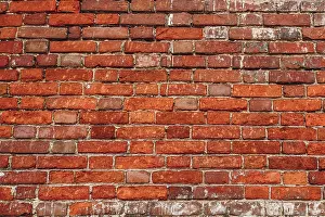 Weathered Brick Wall Prints: Old wall of red and weathered bricks. Background