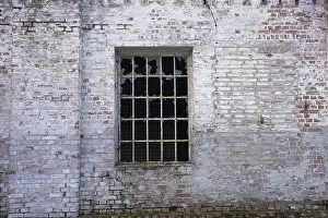 Weathered Brick Wall Prints: An old, weathered brick wall with a broken window