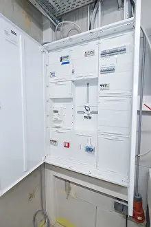 Power Supply Technology Prints: Open electrical cabinet with various control boxes in a technical room
