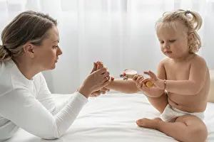 Alternative Medicine Prints: Osteopathist Treating Baby Girl Print