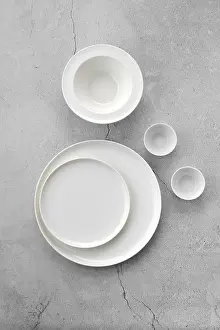 Empty Table Scene Prints: Overhead view of white tableware on grey background