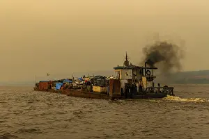 Evening Light On Water Prints: Overloaded riverboat on the Congo river at sunset