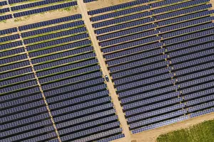 Alternative Energy Source Europe Prints: Overview of solar panel fields with a car on a dirt path
