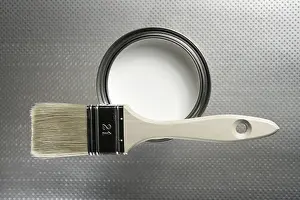 Deserted Studio Setup Prints: Painter brush and white paint tin macro over silver pattern background