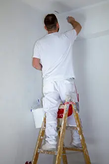 Construction Workman Prints: Painter renovates an old flat