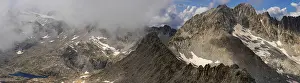 Rugged Mountain Landscape Prints: A panoramic view of a rugged mountain range partially covered by clouds
